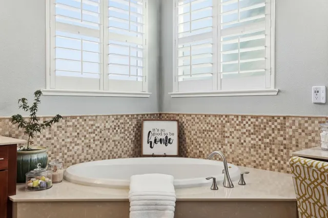 a bath tub sitting next to a window