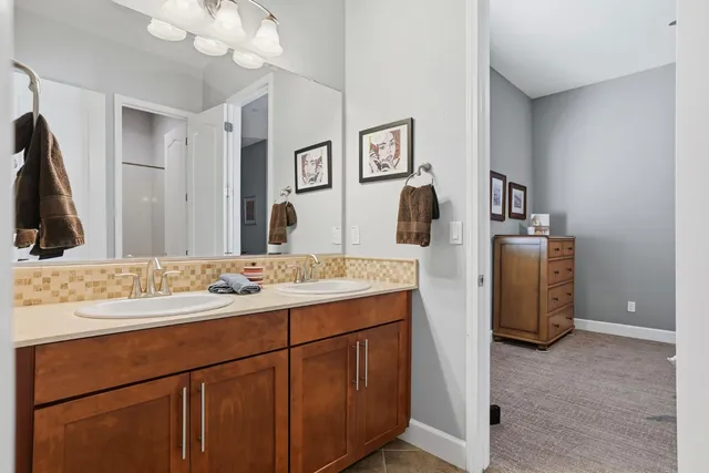 a bathroom with a sink vanity and mirror