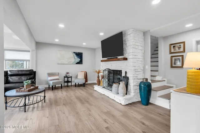 a living room with furniture a fireplace and a flat screen tv