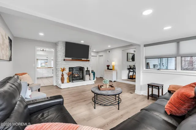 a living room with fireplace furniture and a flat screen tv