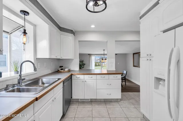 a kitchen with a sink cabinets and refrigerator
