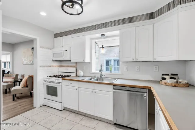 a kitchen with cabinets and white appliances