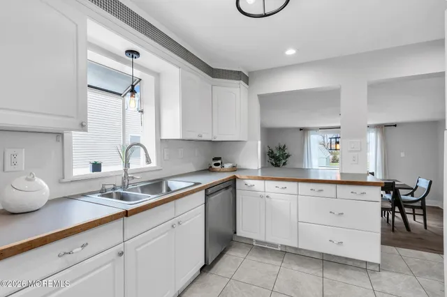 a kitchen with cabinets appliances and a sink