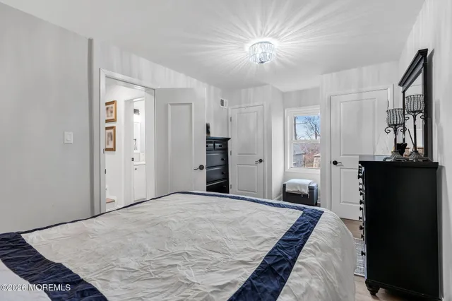 a bedroom with a bed and a television