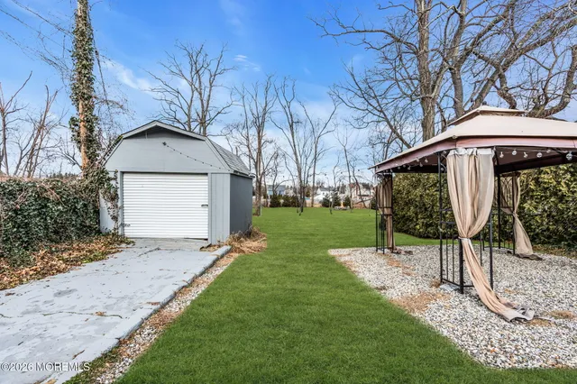 a front view of a house with a yard table and chairs