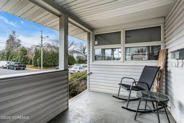 a view of a chair and tables in the balcony
