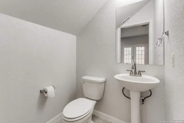 an empty room with closet and windows