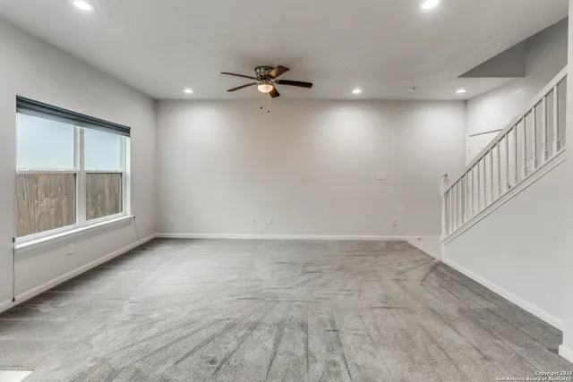 a view of an empty room with a window