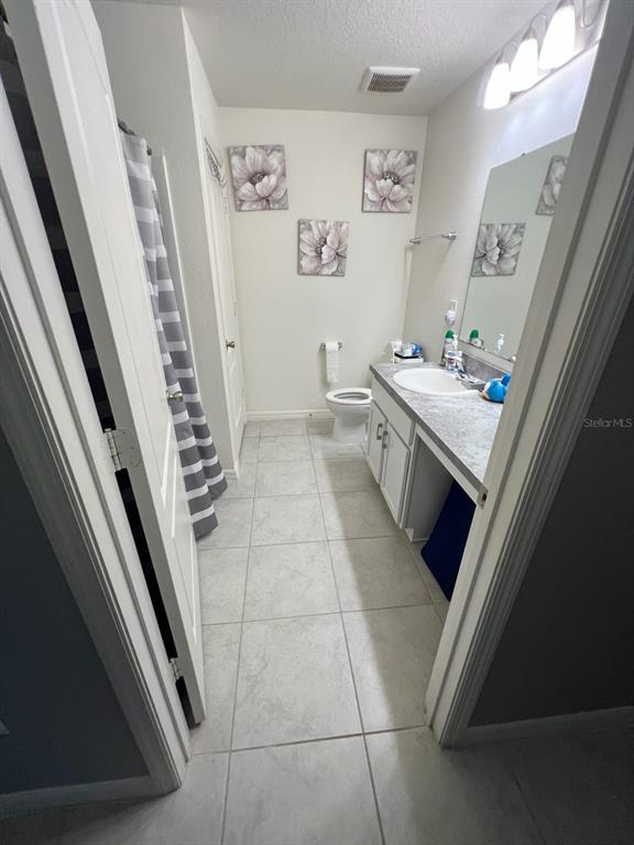 2489 Bulrush Drive St. Cloud, FL 34769 - Photo 17 of 22 a kitchen with a stove and white cabinets