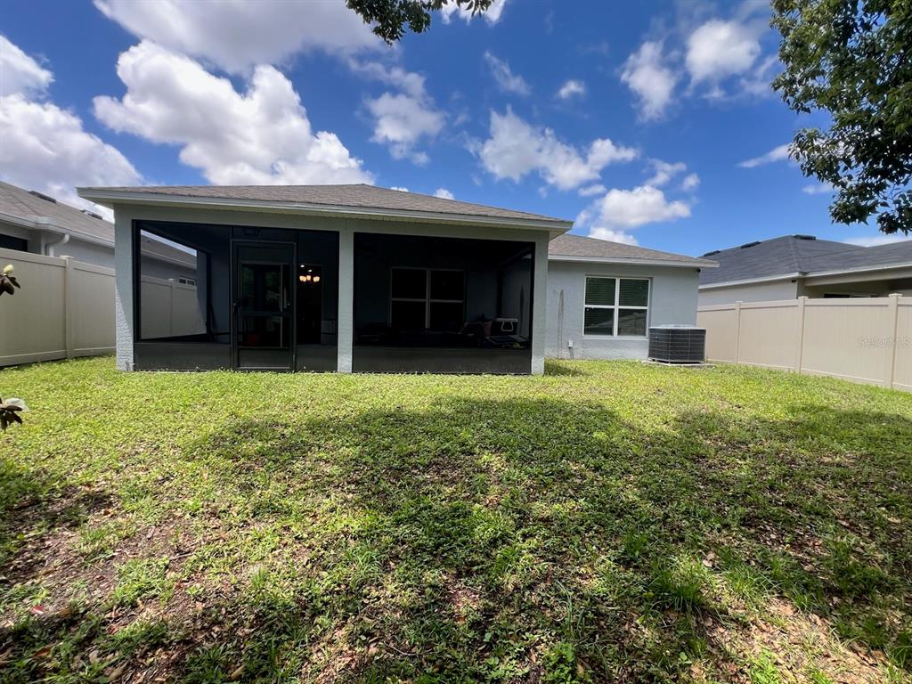 2489 Bulrush Drive St. Cloud, FL 34769 - Photo 20 of 22 a view of a house with a yard