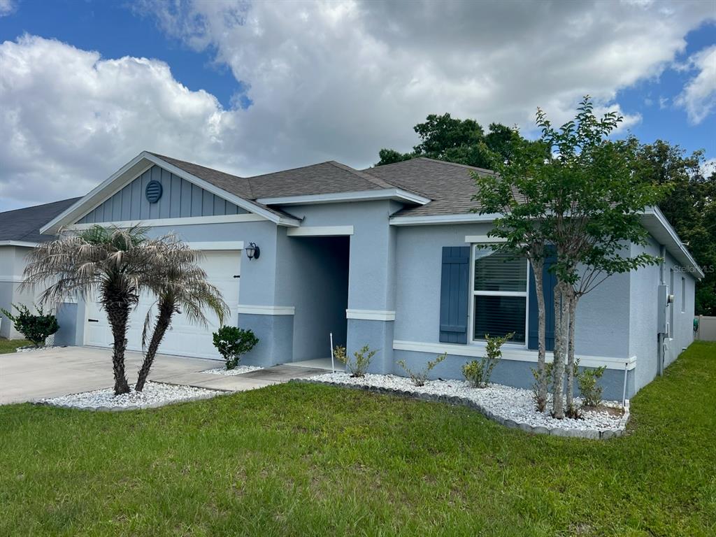 2489 Bulrush Drive St. Cloud, FL 34769 - Photo 2 of 22 a front view of a house with a yard