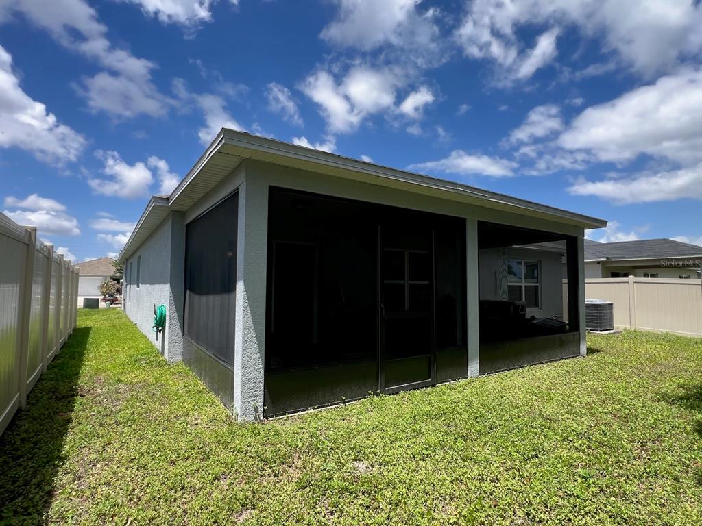 2489 Bulrush Drive St. Cloud, FL 34769 - Photo 22 of 22 a view of a house with a yard