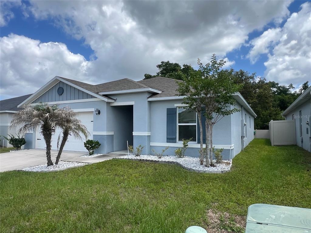 2489 Bulrush Drive St. Cloud, FL 34769 - Photo 4 of 22 a front view of a house with a yard