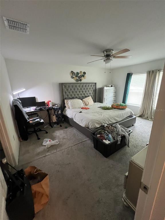 2489 Bulrush Drive St. Cloud, FL 34769 - Photo 10 of 22 a bedroom with a bed and a chair