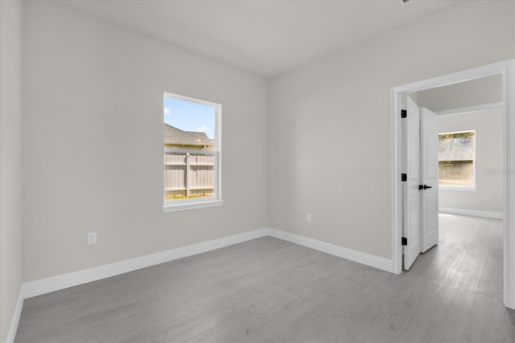 15782 Southwest 52nd Ave Road Ocala, FL 34473 - Photo 17 of 34 an empty room with a window and wooden floor
