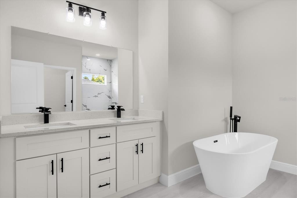 15782 Southwest 52nd Ave Road Ocala, FL 34473 - Photo 25 of 34 a bathroom with a bathtub and a sink