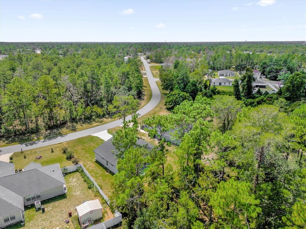 15782 Southwest 52nd Ave Road Ocala, FL 34473 - Photo 33 of 34 an aerial view of a house with a yard and lake view