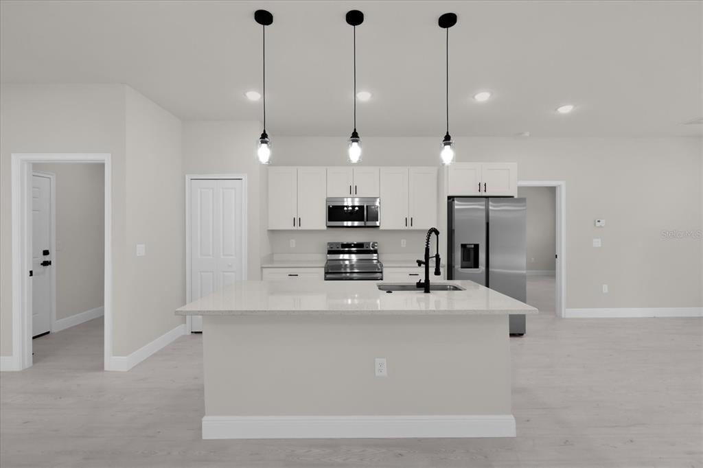 15782 Southwest 52nd Ave Road Ocala, FL 34473 - Photo 8 of 34 a kitchen with kitchen island a counter top stainless steel appliances and cabinets