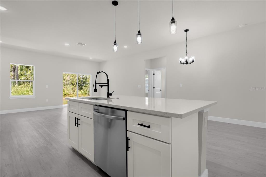 15782 Southwest 52nd Ave Road Ocala, FL 34473 - Photo 10 of 34 a kitchen with stainless steel appliances granite countertop a sink a counter space and a window