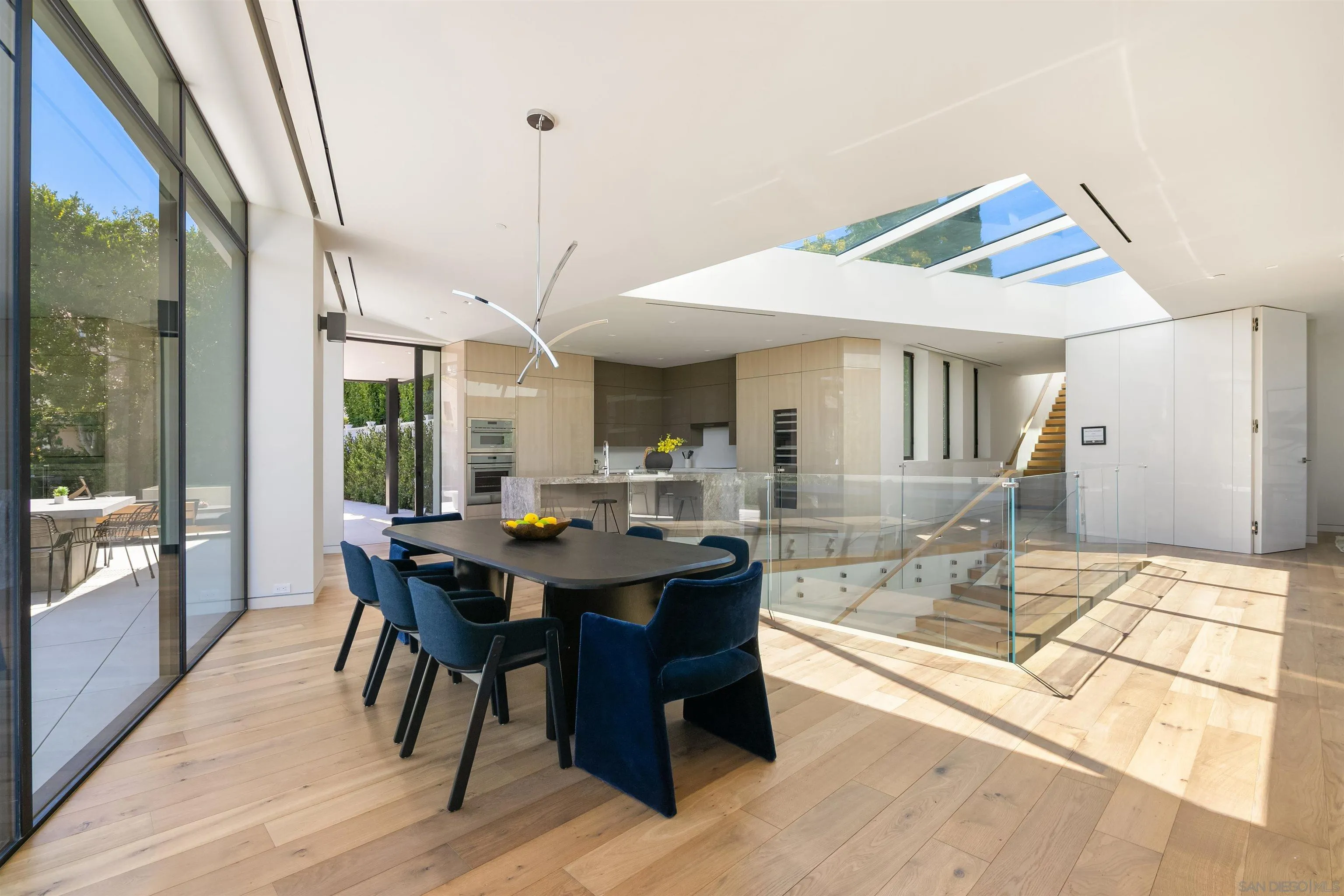 7837 Lookout Drive La Jolla, CA 92037 - Photo 15 of 46 a dining hall with stainless steel appliances granite countertop a dining table and chairs with wooden floor