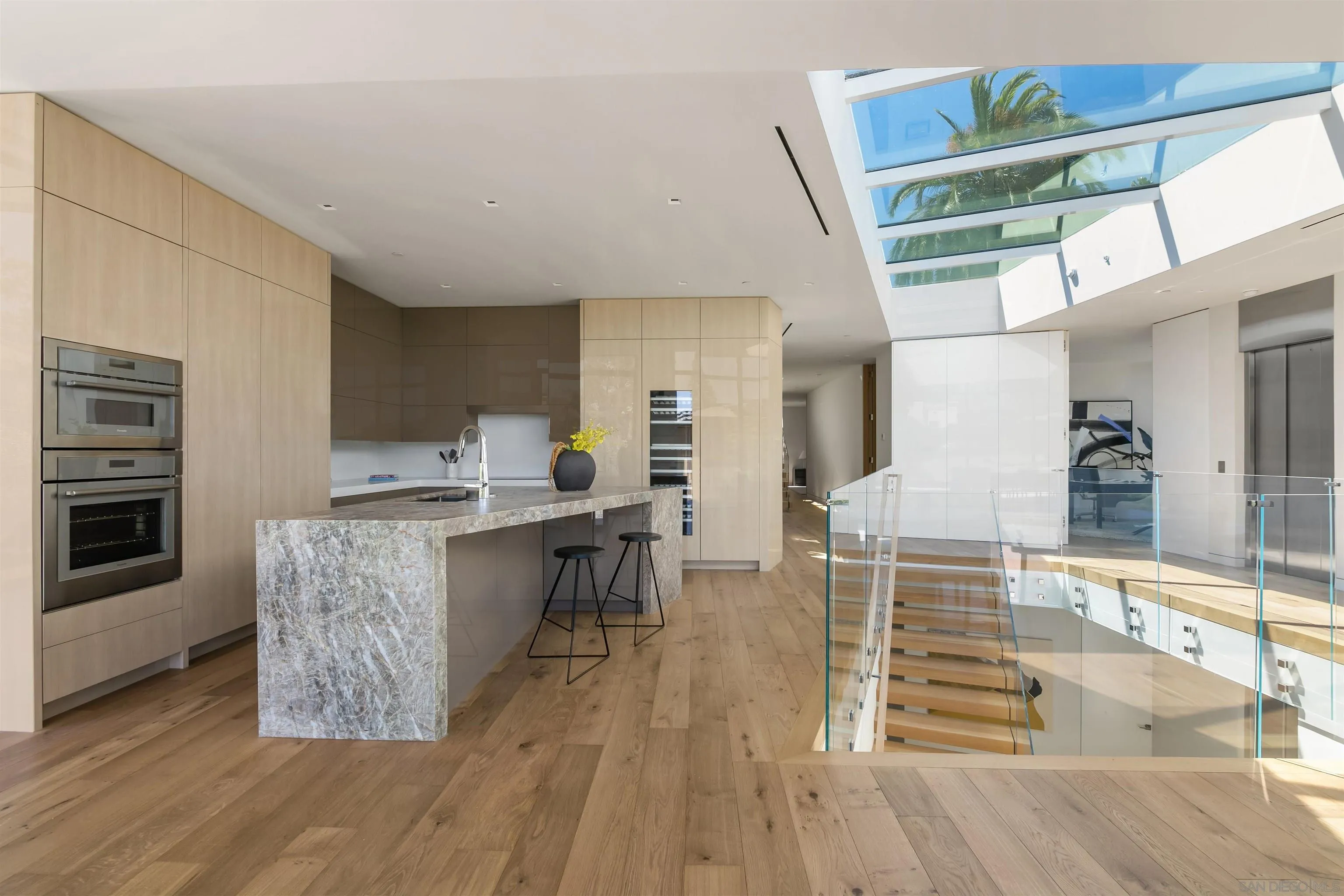 7837 Lookout Drive La Jolla, CA 92037 - Photo 18 of 46 a kitchen with stainless steel appliances granite countertop a stove and a wooden floors