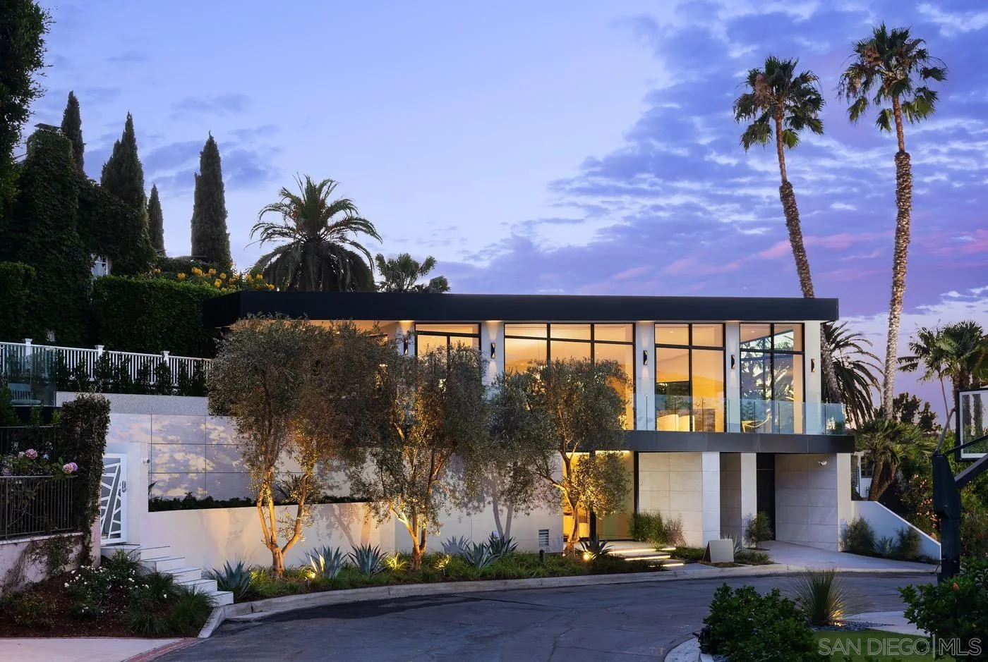 7837 Lookout Drive La Jolla, CA 92037 - Photo 3 of 46 a front view of a house with a garden
