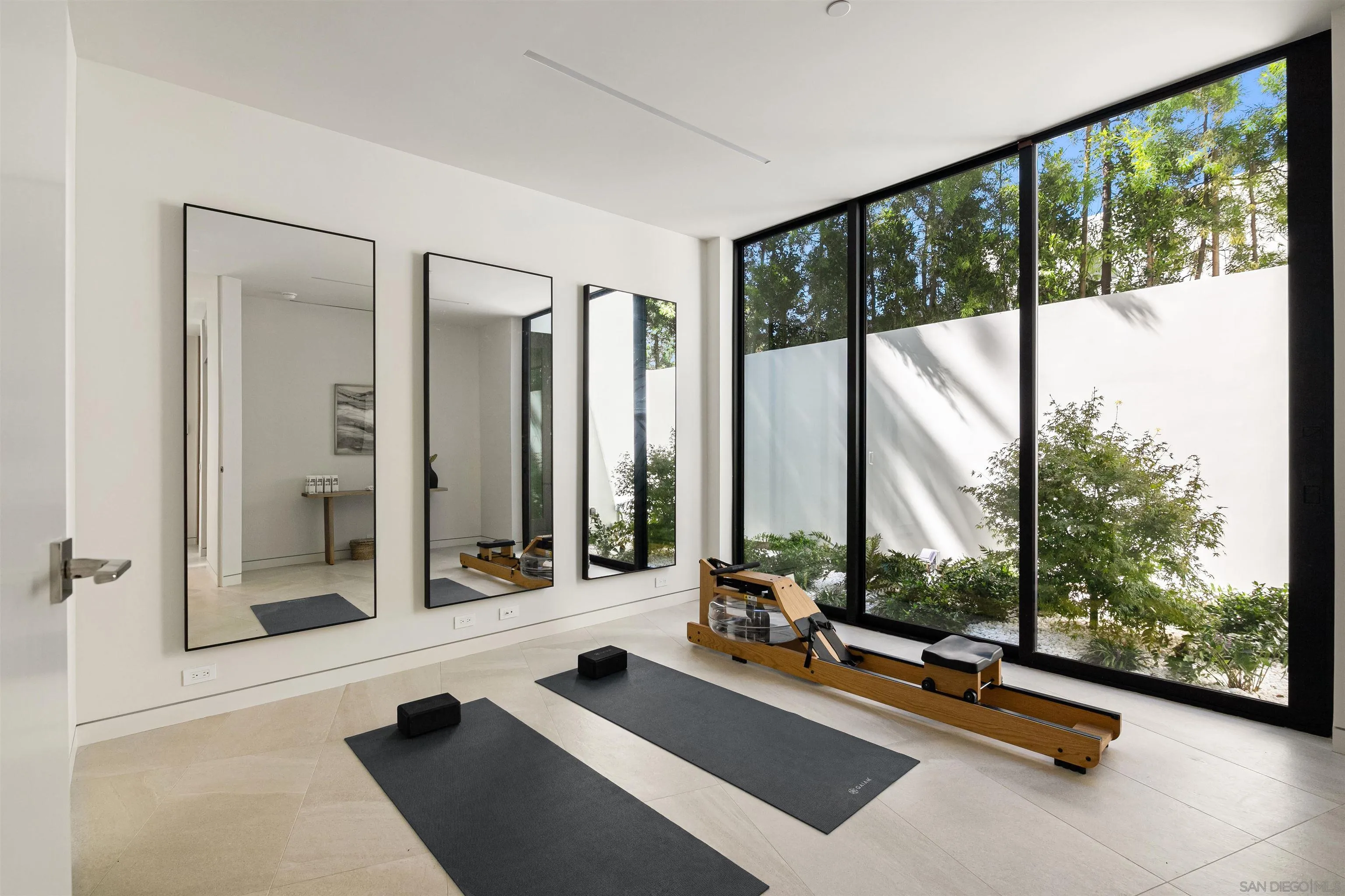 7837 Lookout Drive La Jolla, CA 92037 - Photo 38 of 46 a view of a room with gym equipment and floor to ceiling window
