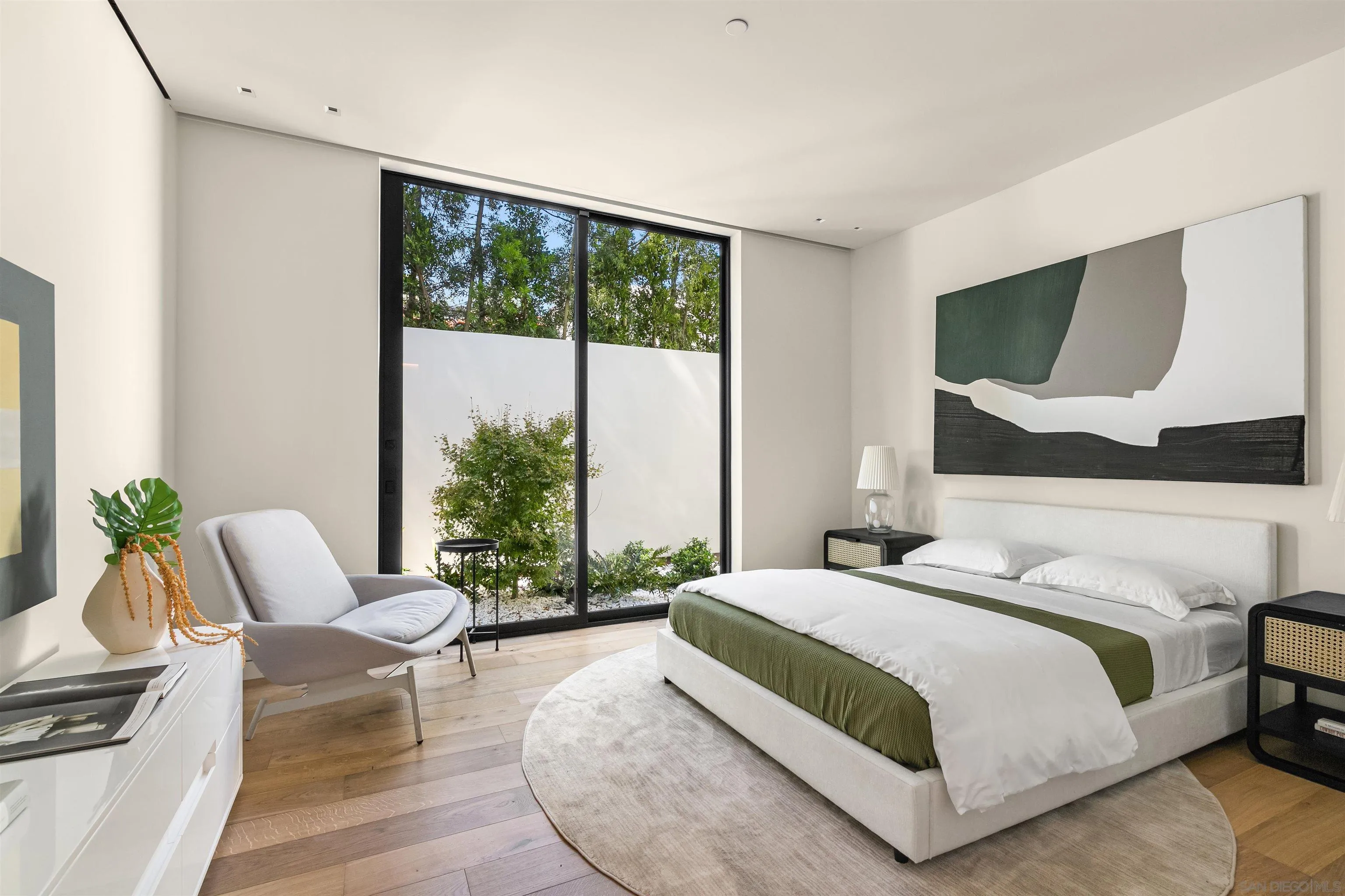 7837 Lookout Drive La Jolla, CA 92037 - Photo 40 of 46 a spacious bedroom with a bed and glass window