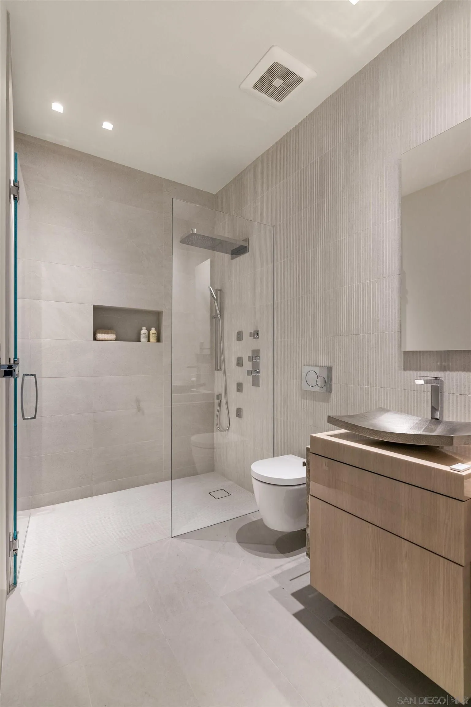 7837 Lookout Drive La Jolla, CA 92037 - Photo 41 of 46 a spacious bathroom with a double vanity sink toilet and shower