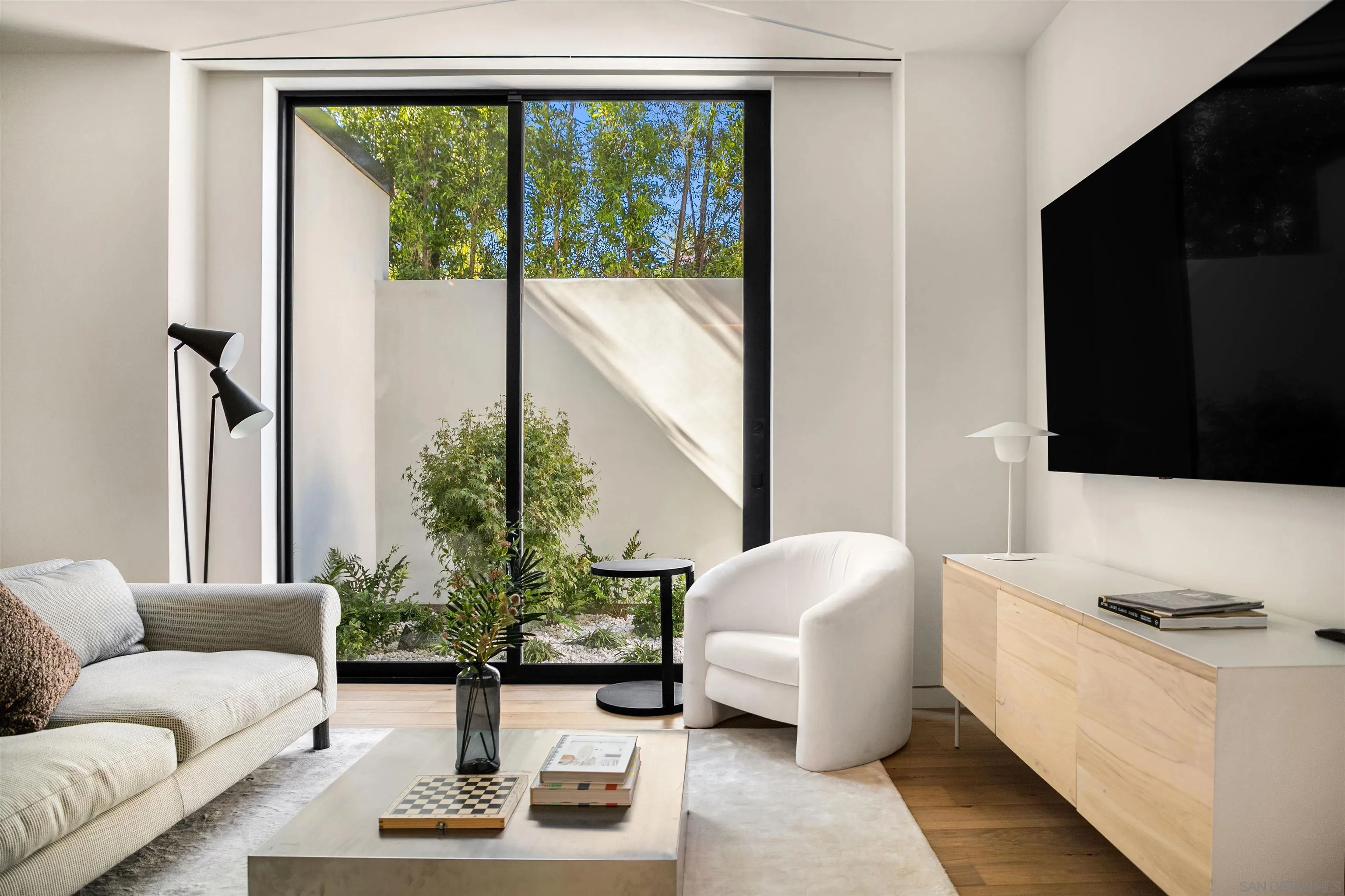 7837 Lookout Drive La Jolla, CA 92037 - Photo 43 of 46 a living room with furniture and a flat screen tv