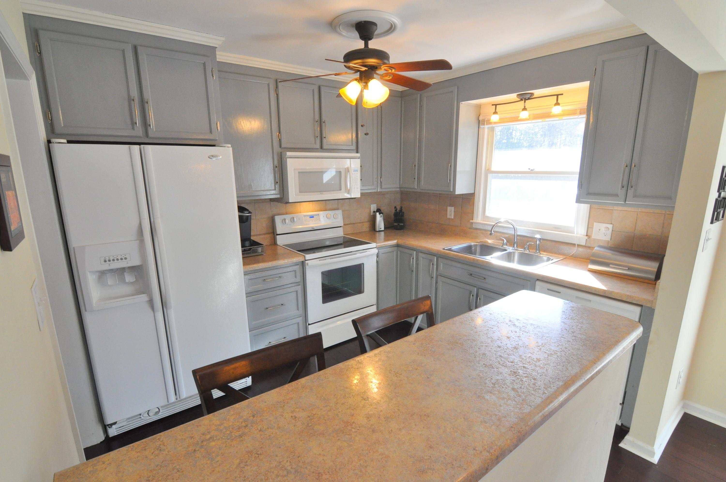 337 Fields Avenue Blue Ridge, VA 24064 - Photo 4 of 23 a kitchen with a refrigerator a stove a sink and a window