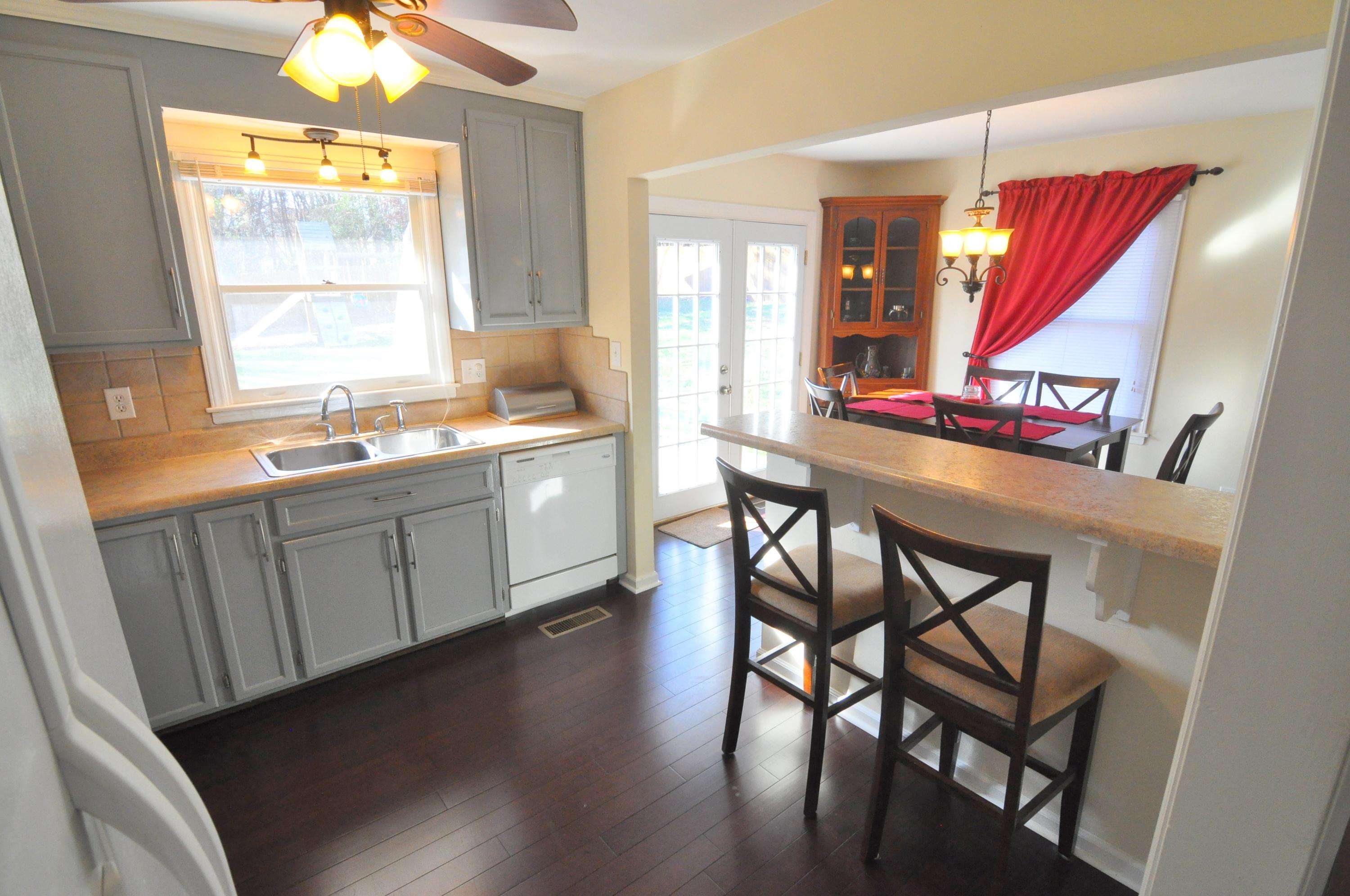 337 Fields Avenue Blue Ridge, VA 24064 - Photo 5 of 23 a kitchen with stainless steel appliances granite countertop wooden cabinets stove dining table and chairs