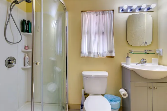 a bathroom with a sink mirror vanity and toilet