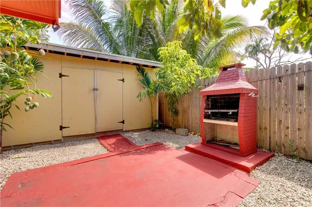 a view of backyard with outdoor seating and trees