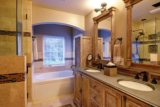 a bathroom with a tub sink and mirror