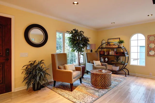 a living room with furniture and a floor to ceiling window