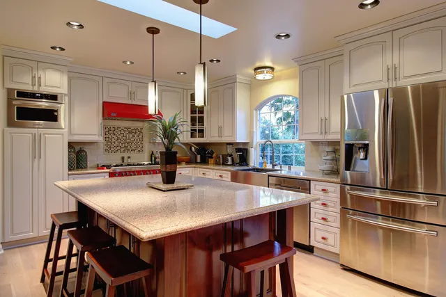 a kitchen with refrigerator and wooden floor