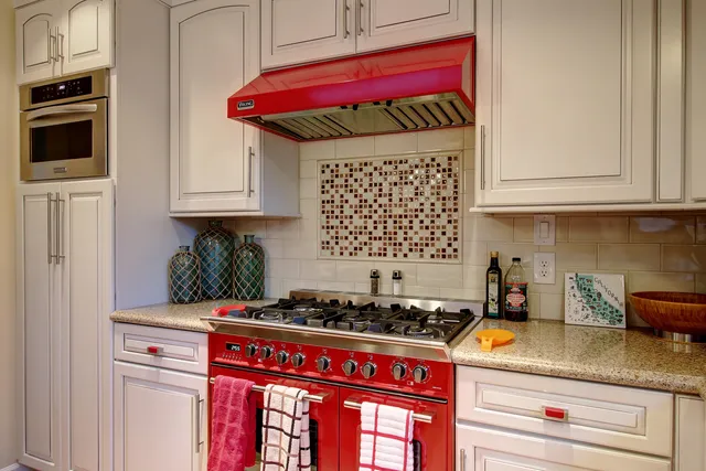 a kitchen with a stove and a white refrigerator