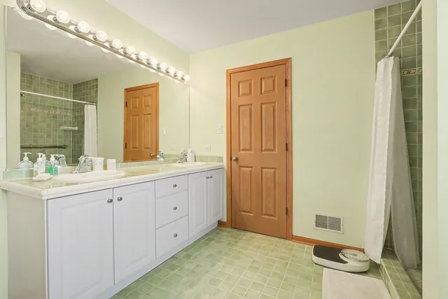 a en suite bathroom with a sink a mirror and a shower