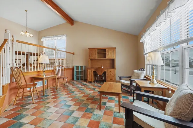 a living room with furniture a rug and a window
