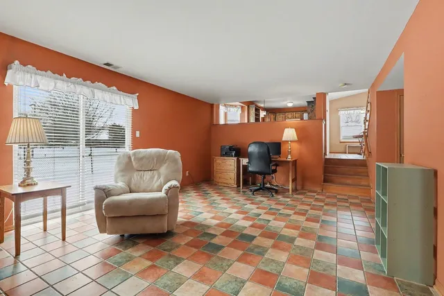 a living room with furniture and a floor to ceiling window