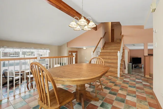 a dining room with furniture and a chandelier