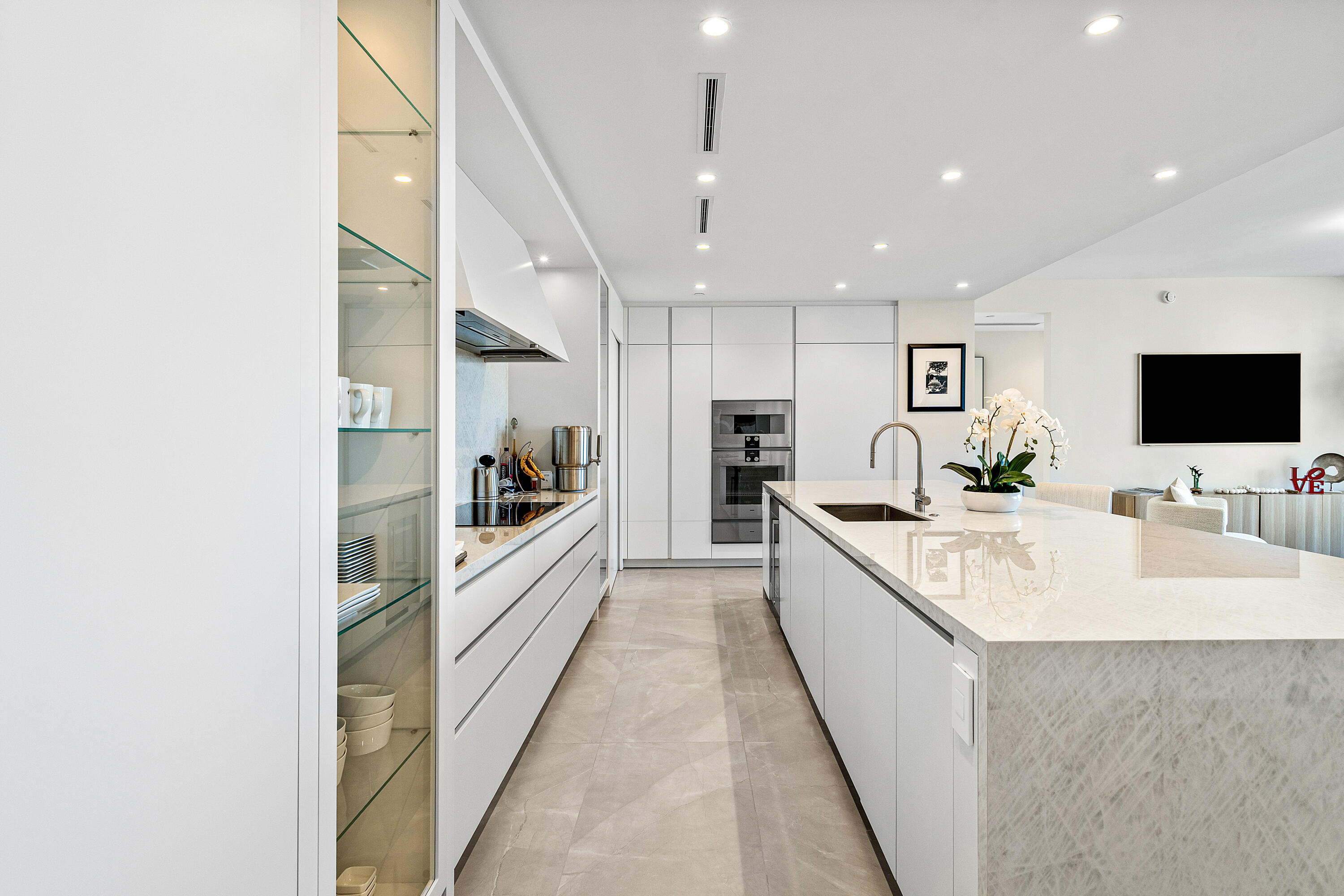 220 Southeast Mizner Boulevard, Unit 810 Boca Raton, FL 33432 - Photo 14 of 39 a large white kitchen with a large window and stainless steel appliances
