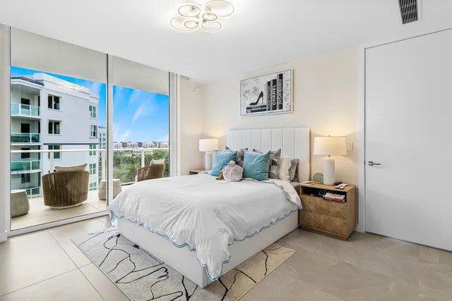 a bedroom with a bed a couch and a window