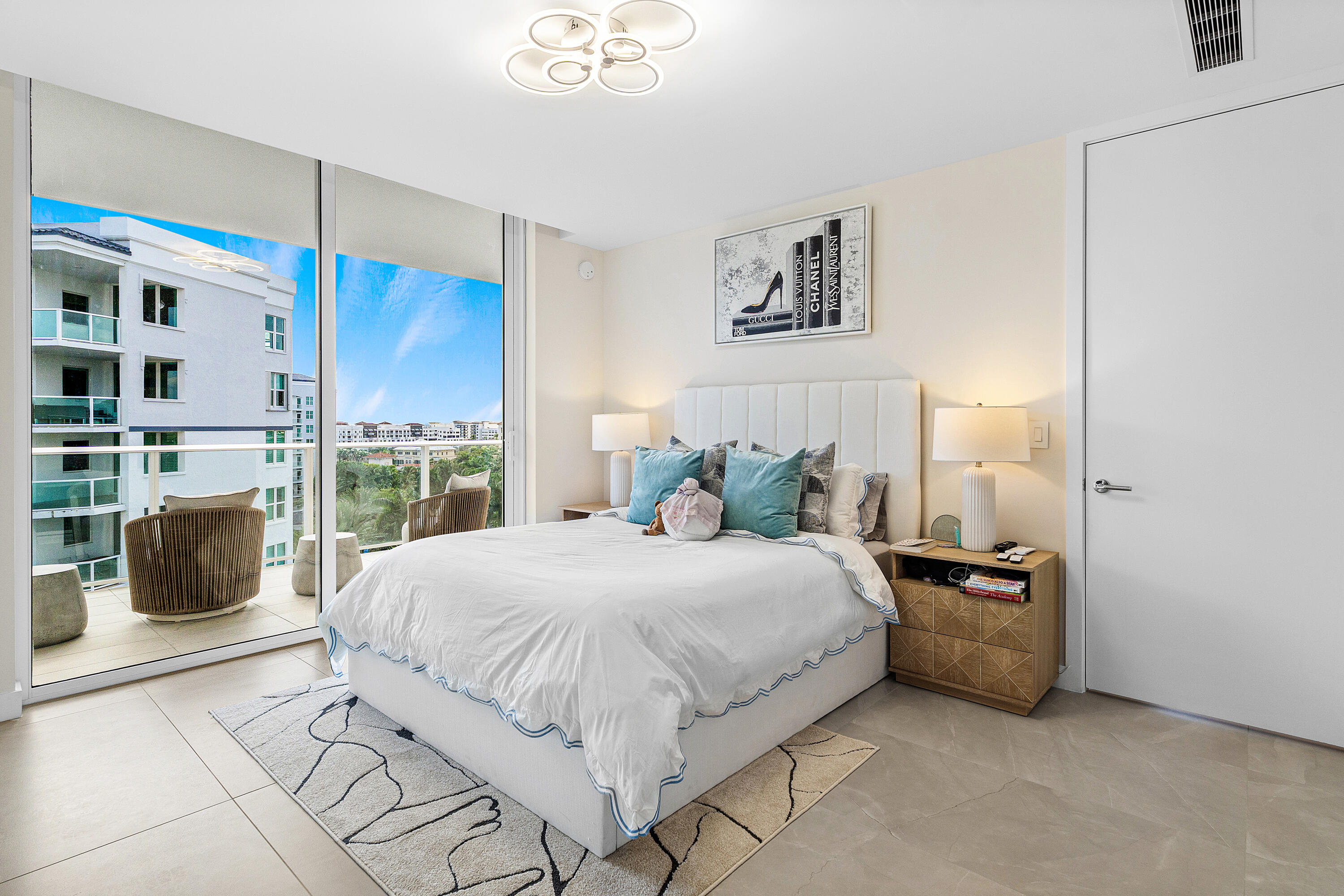 220 Southeast Mizner Boulevard, Unit 810 Boca Raton, FL 33432 - Photo 16 of 39 a bedroom with a bed a couch and a window