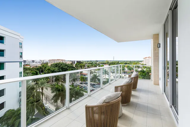 a view of a balcony with couches and wooden floor