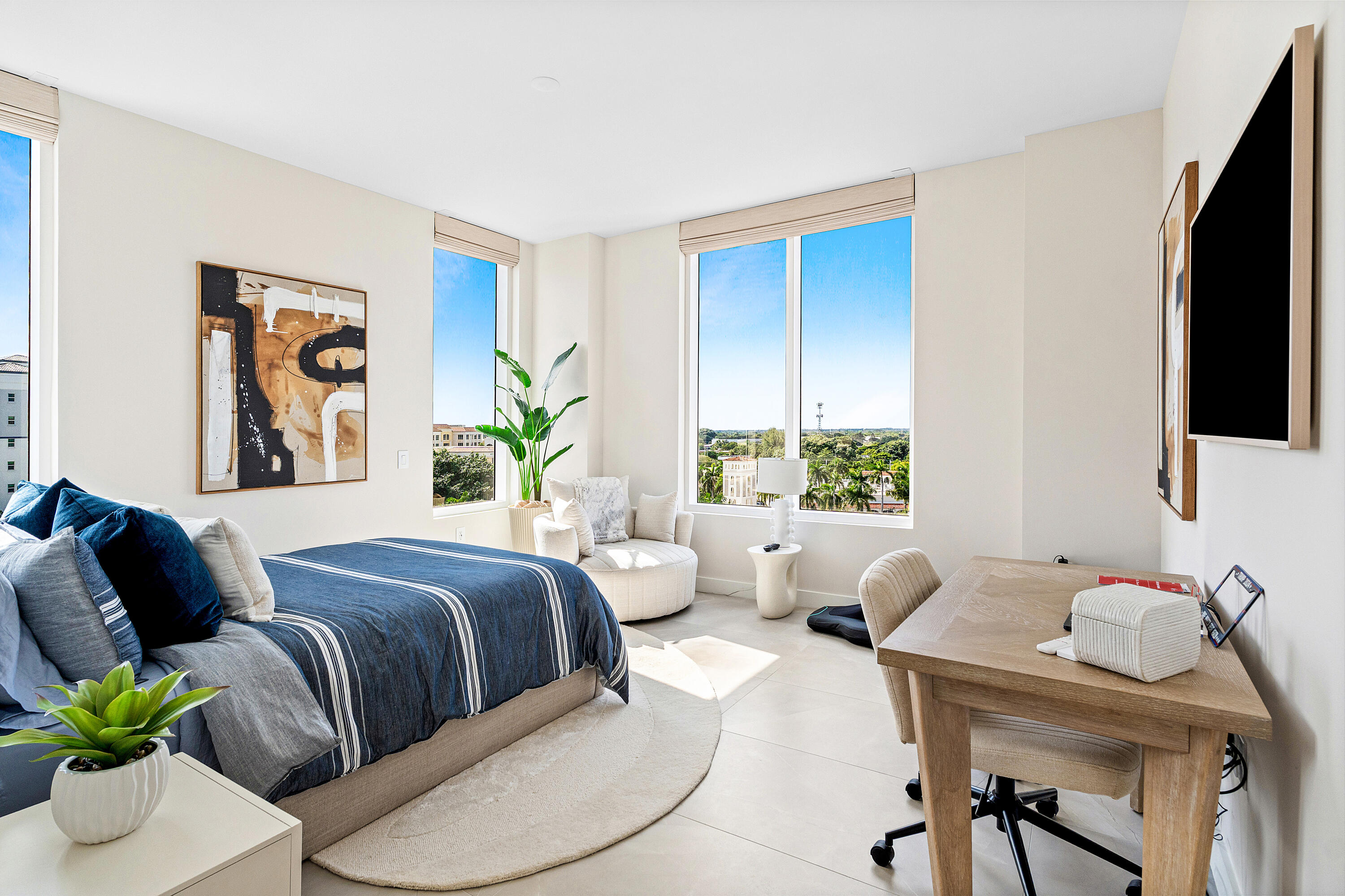 220 Southeast Mizner Boulevard, Unit 810 Boca Raton, FL 33432 - Photo 19 of 39 a bedroom with two beds and a potted plant