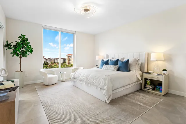 a bedroom with a bed and a potted plant