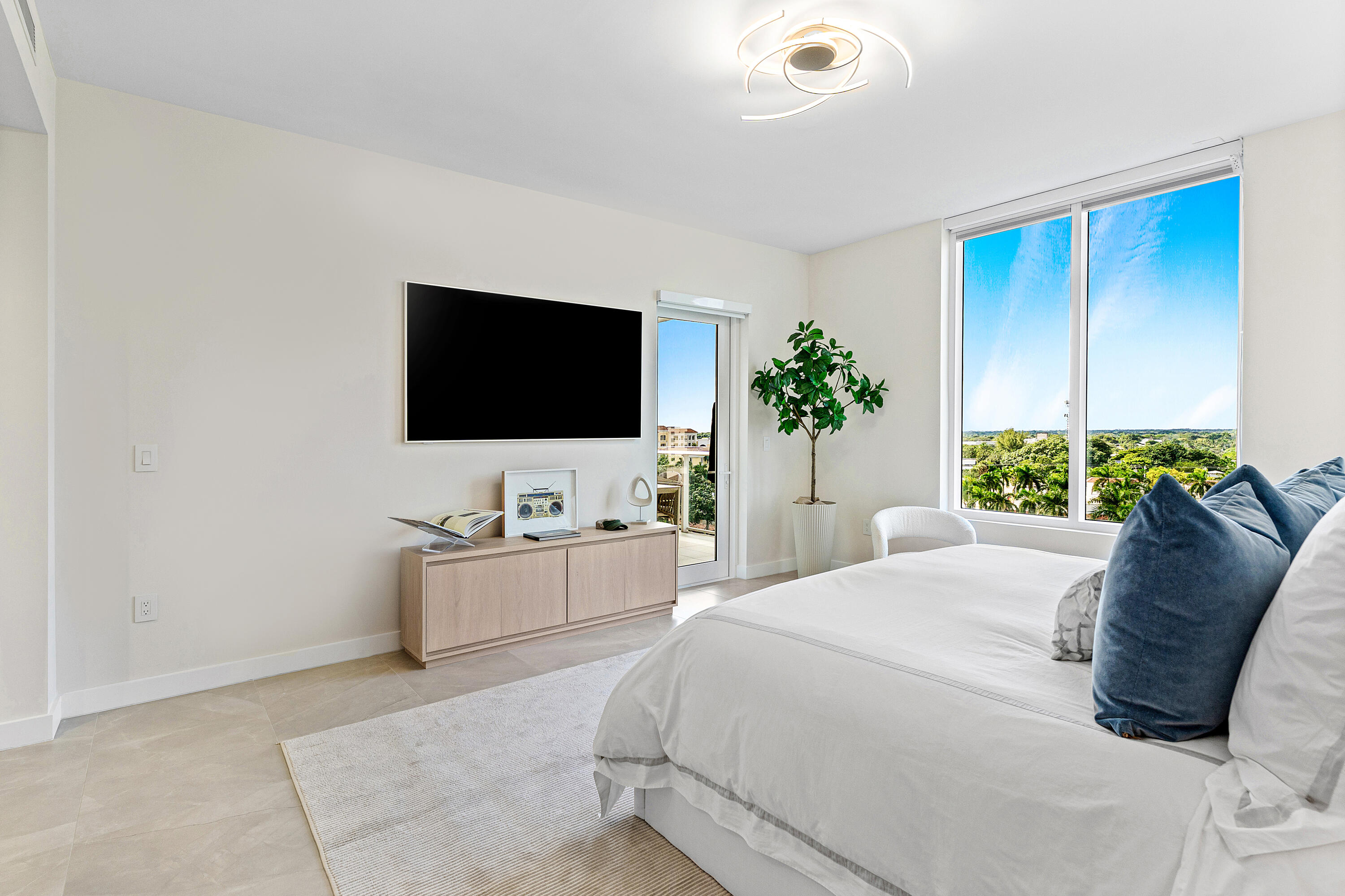 220 Southeast Mizner Boulevard, Unit 810 Boca Raton, FL 33432 - Photo 7 of 39 a living room with furniture and a flat screen tv