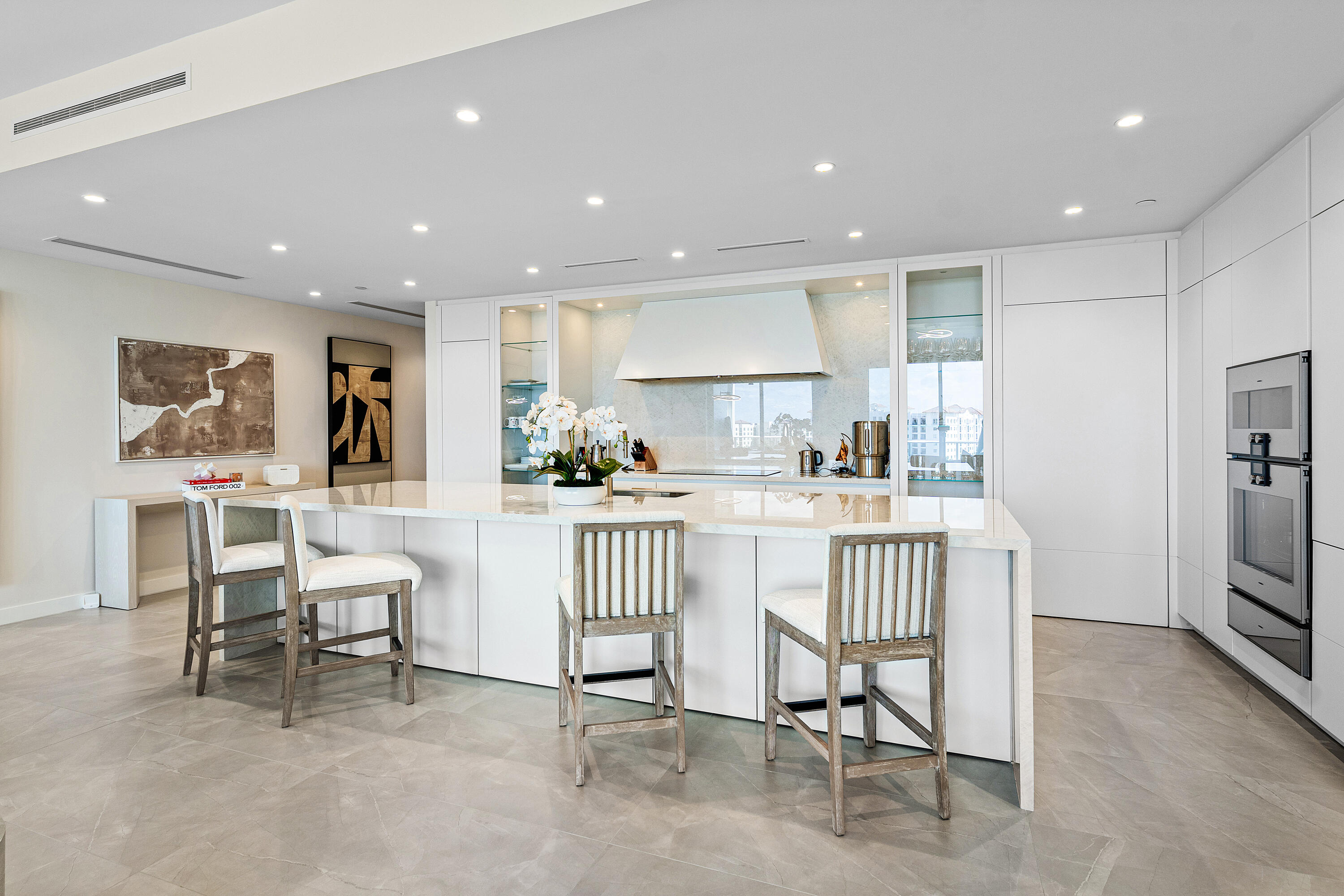 220 Southeast Mizner Boulevard, Unit 810 Boca Raton, FL 33432 - Photo 8 of 39 a kitchen with stainless steel appliances kitchen island granite countertop a refrigerator and cabinets